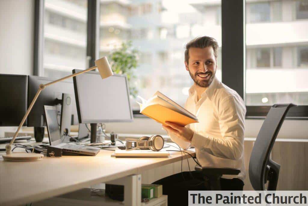 Photo of Man Holding a Book