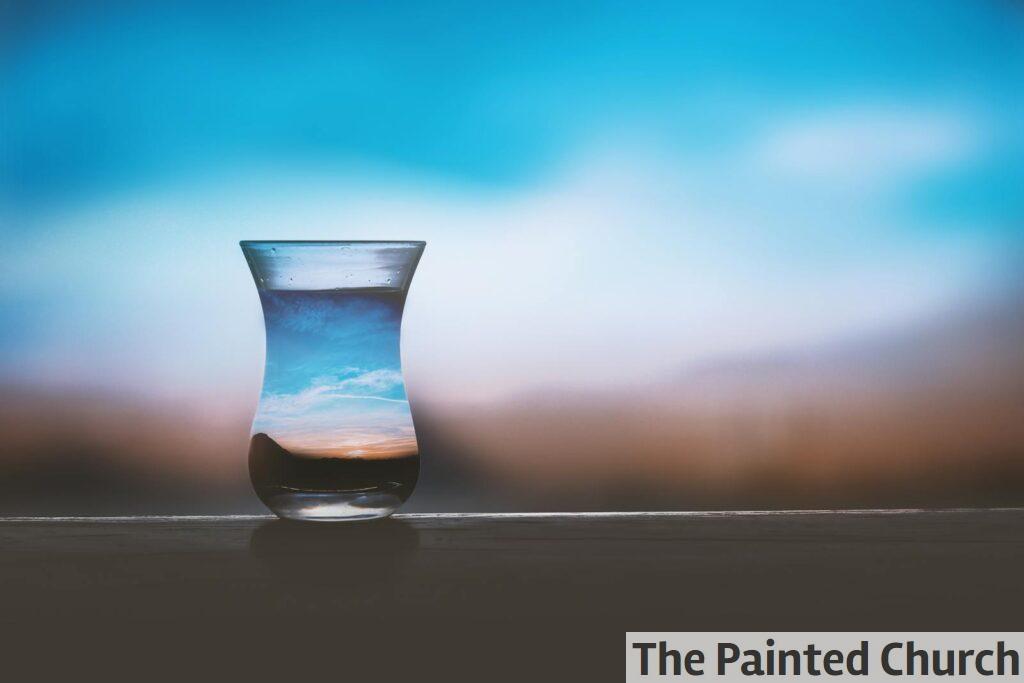 Artistic capture of a sunset reflection in a glass with a calm blue sky. Perfect simplicity.