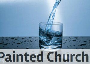 High-quality image of water being poured into a glass, illustrating hydration and purity.