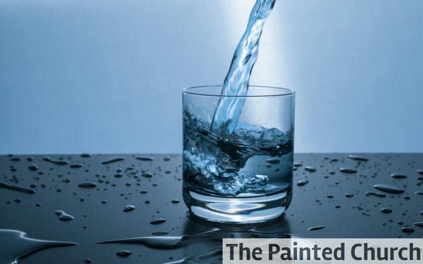 High-quality image of water being poured into a glass, illustrating hydration and purity.