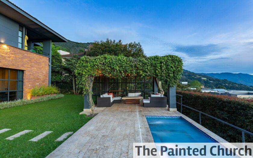 a house with a swimming pool in front of it