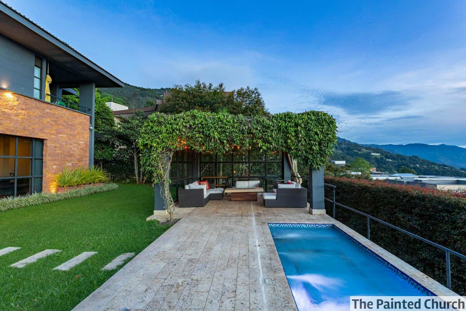 a house with a swimming pool in front of it